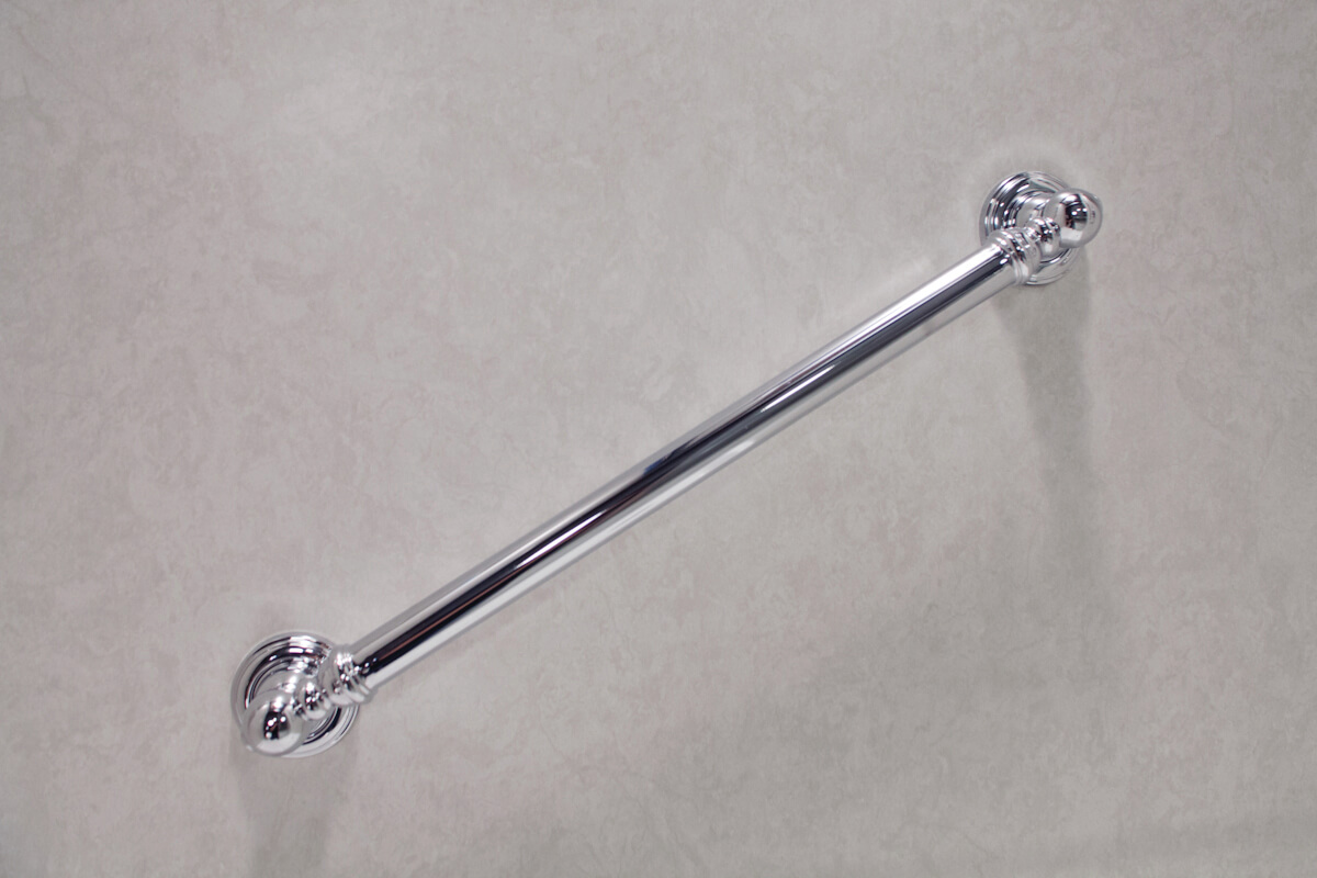 Modern chrome towel bar fixed to a pristine white wall, ideal for a stylish bathroom setting.