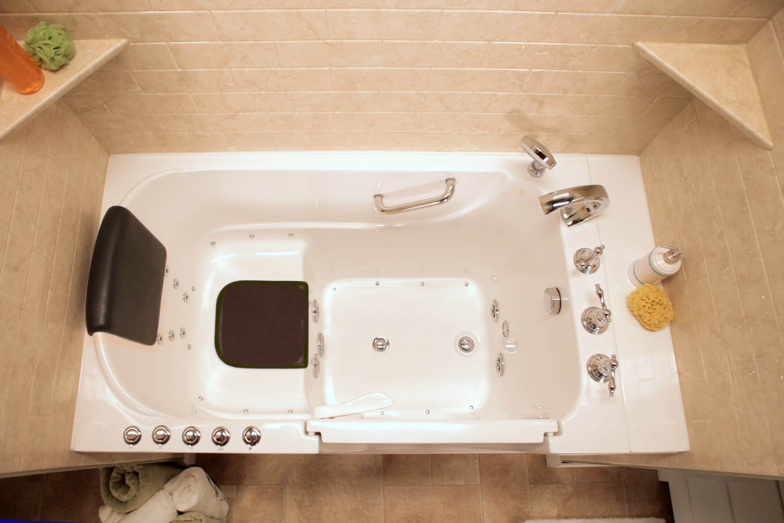 Walk In Bath Product Type A bathroom scene featuring a bathtub with a seat beside a toilet, designed for accessibility and comfort.